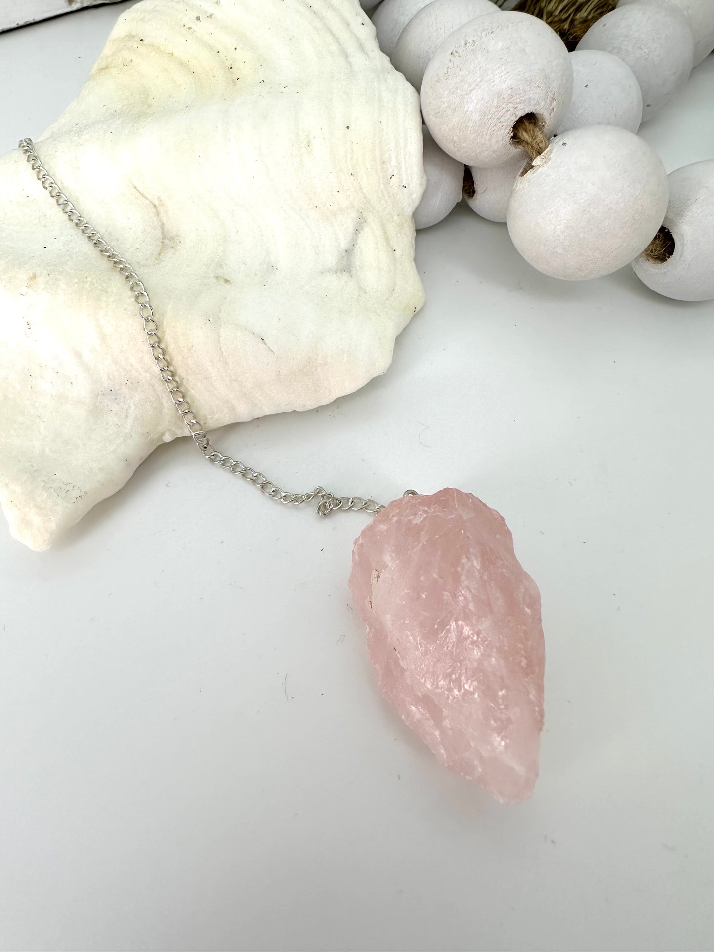 Chunky raw rose quartz is pendulum