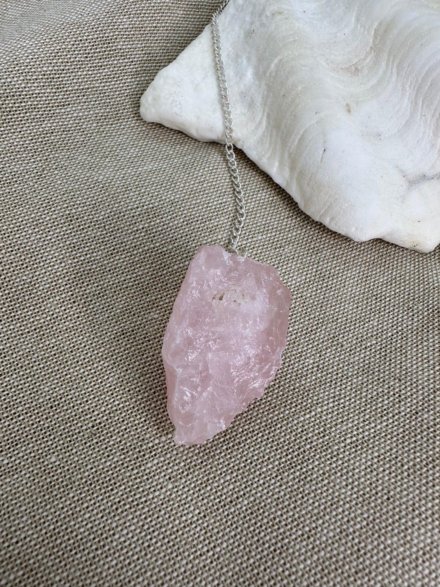 Chunky raw rose quartz is pendulum