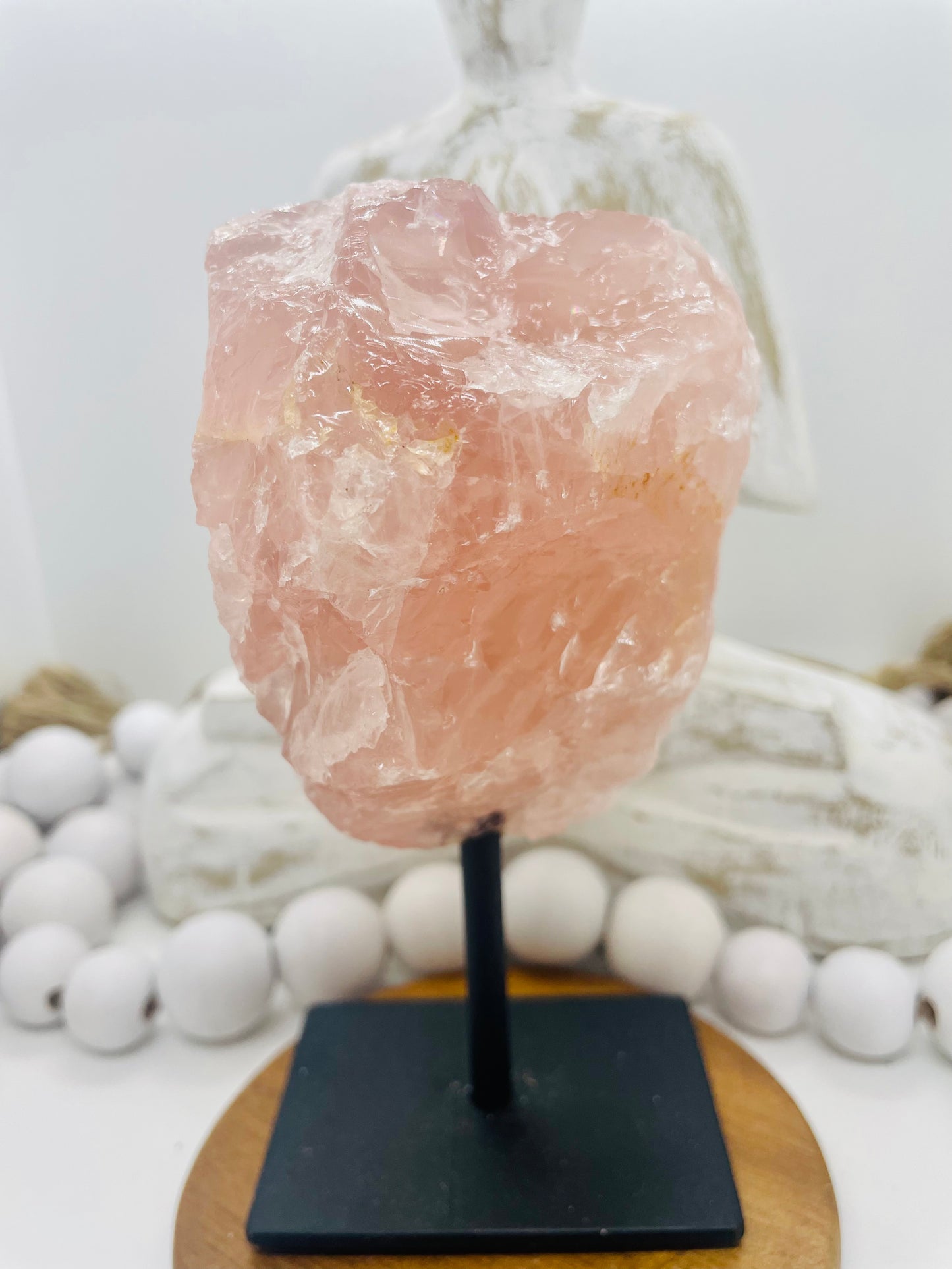 Rose quartz raw on display stand